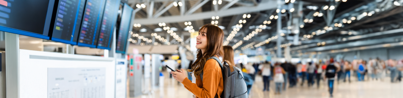 Mminiatura Cp Working Holiday 1366x332 Mujer joven sonriendo en el aeropuerto
